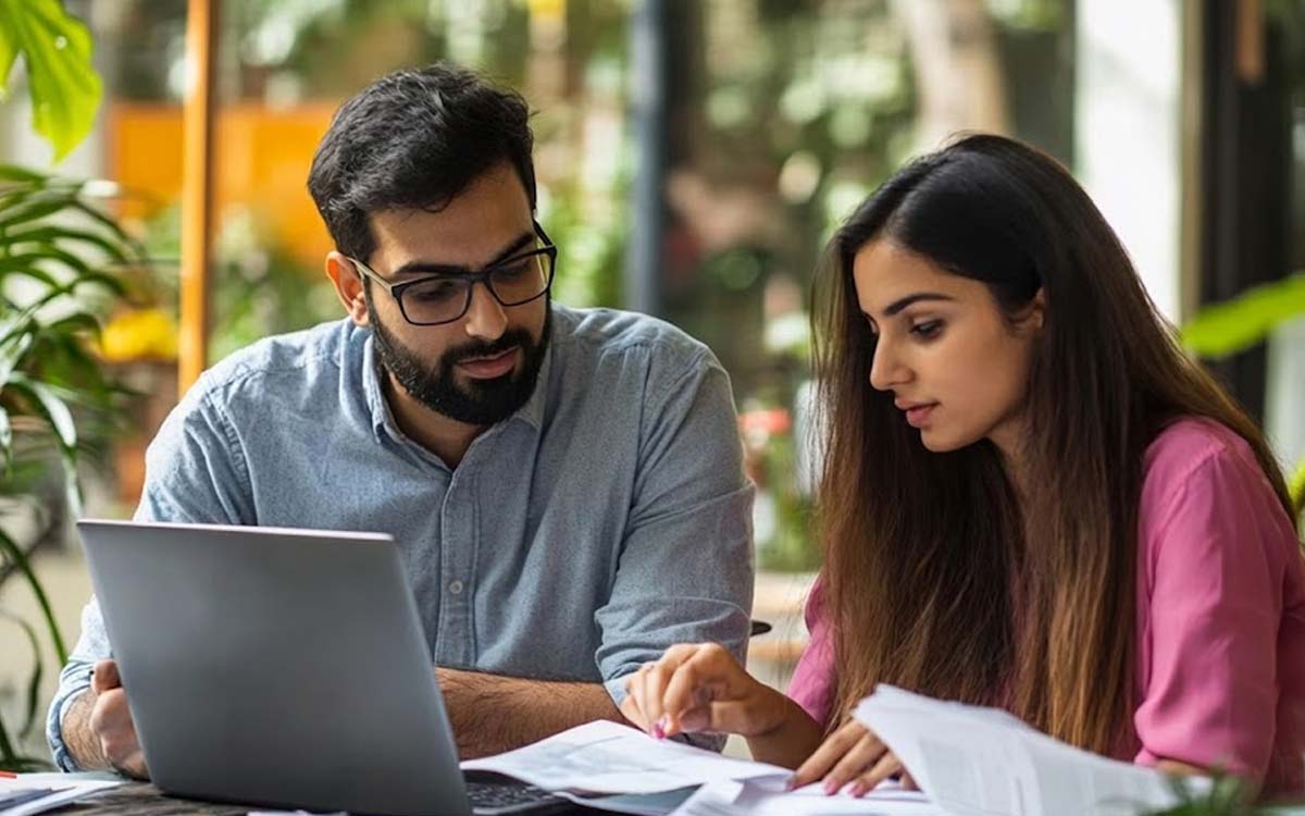 Counsellor and student reviewing university options on a laptop at The Mentors Circle Noida